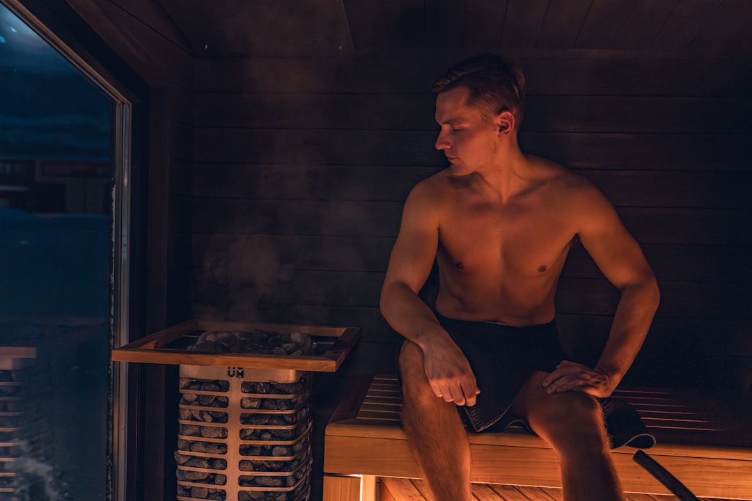 A man relaxing in a sauna before his next contrast therapy cold plunge cycle