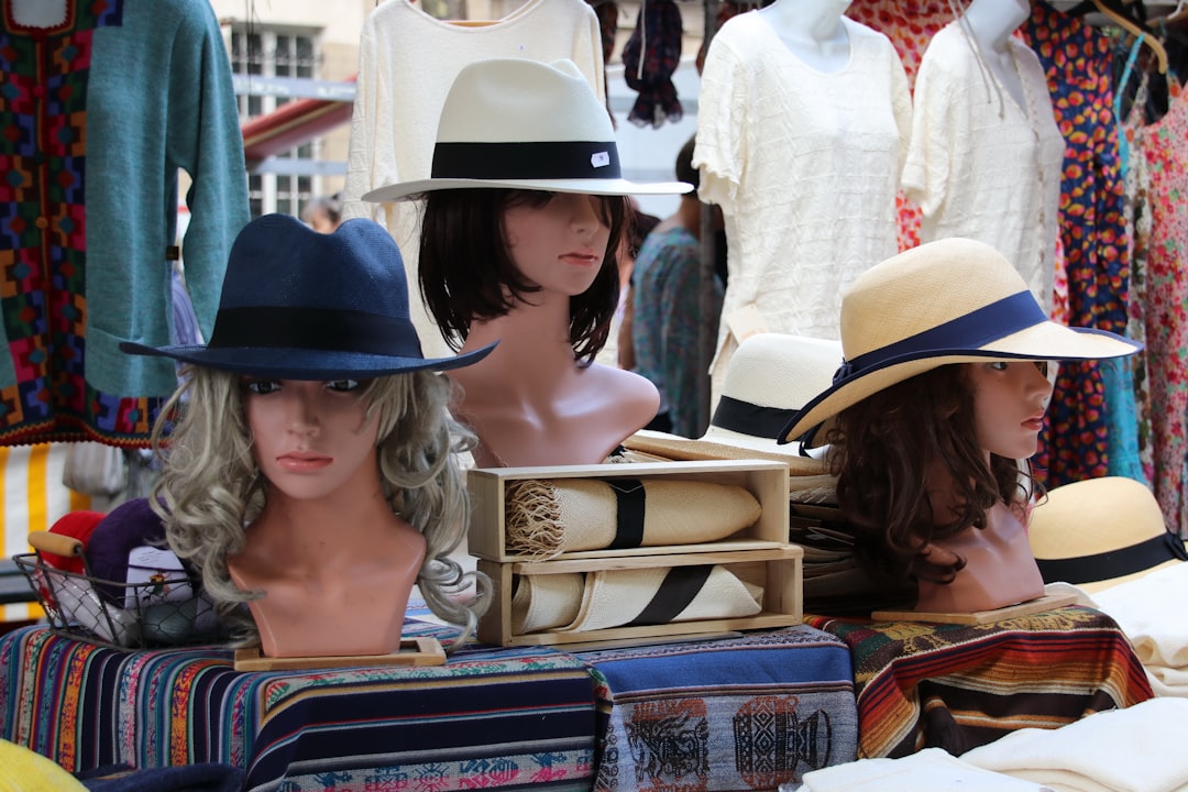 A shopper examining upcycled pieces at a Singapore market stall to complete a secondhand outfit for National Day