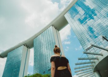 A Singapore businesswoman presents data on local businesses to colleagues in a modern CBD office