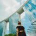 singapore-businesswoman-office-presentation-unsplash - SINwebzine A Singapore businesswoman presents data on local businesses to colleagues in a modern CBD office