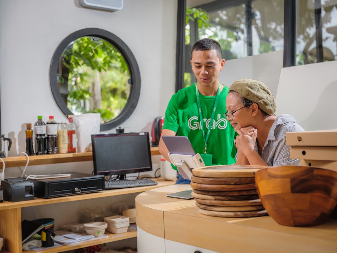 An SME owner in Singapore reviews AI incentive documents that affect local businesses at his desk
