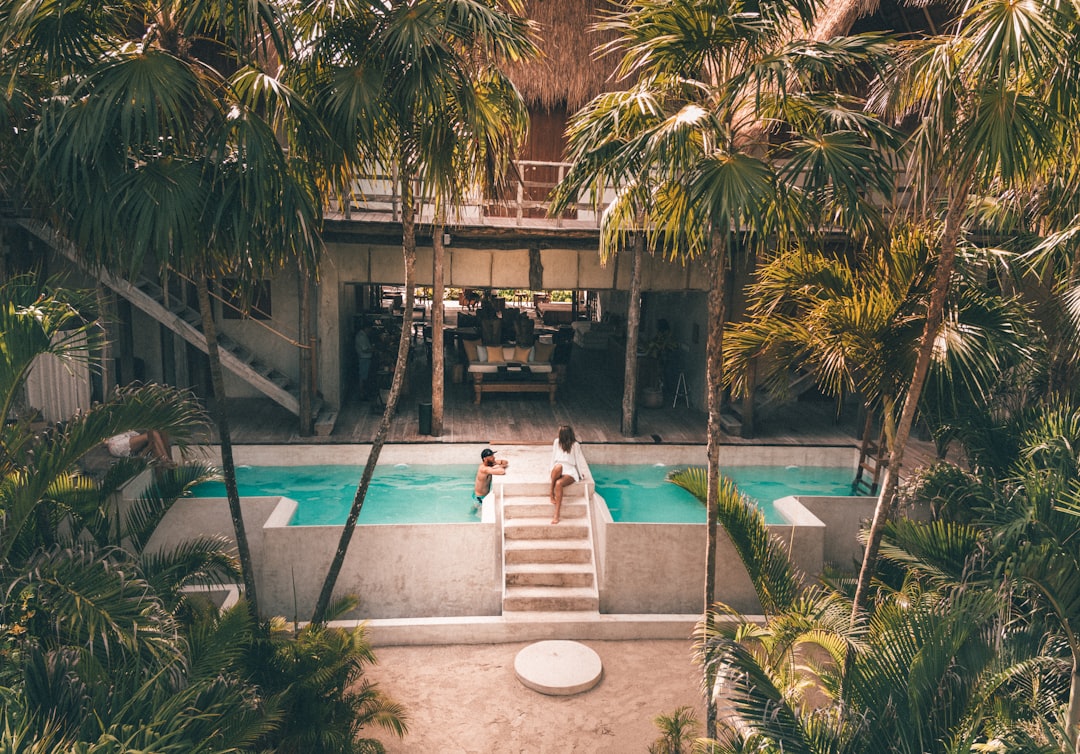 Two people enjoying a hot pool rest period between contrast therapy rounds at a Singapore bathhouse
