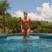 A woman preparing to enter a cold plunge pool as part of a contrast therapy session at a Singapore bathhouse
