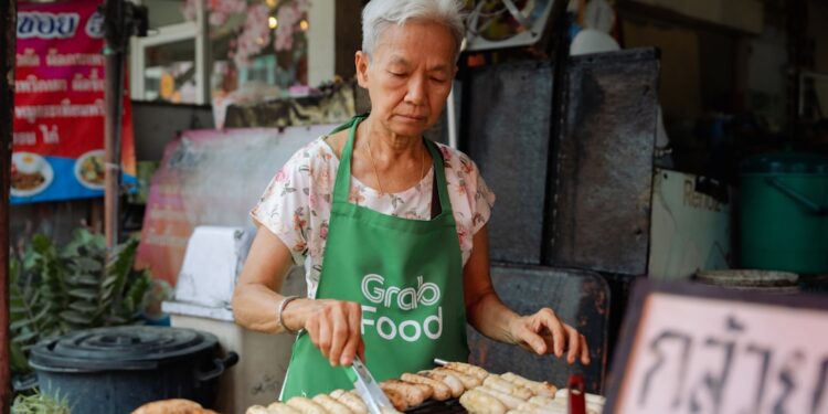 woman-eating-hawker-centre-singapore-unsplash - SINwebzine A woman enjoying a plate of food at a Singapore vegetarian hawker stall in a busy food centre