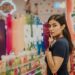 woman-reading-product-label-supermarket-unsplash - SINwebzine A woman reads a zero waste label on a household product in a Singapore supermarket aisle.