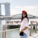 woman-singapore-linen-outfit-street-unsplash - SINwebzine A woman in a breathable linen set walking through a Singapore street, a practical capsule wardrobe for the city's climate.
