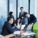 asian-business-professionals-in-meeting-unsplash - SINwebzine Two corporate executives reviewing F1 hospitality packages at a trackside suite during the Singapore Grand Prix weekend