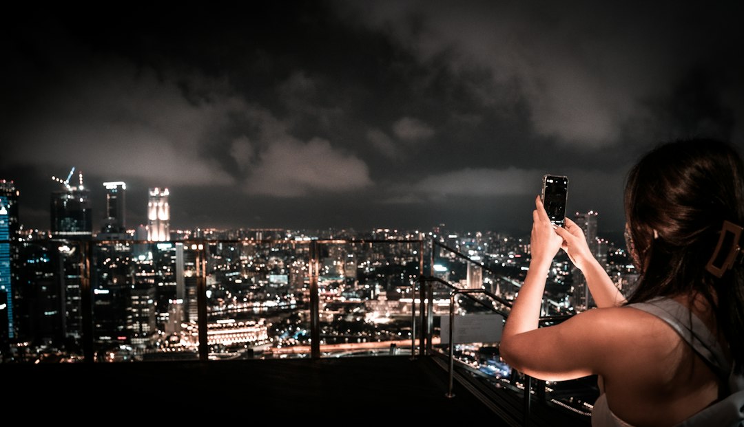 Business professionals networking at a rooftop dinner event during F1 hospitality week in Singapore's Marina Bay district