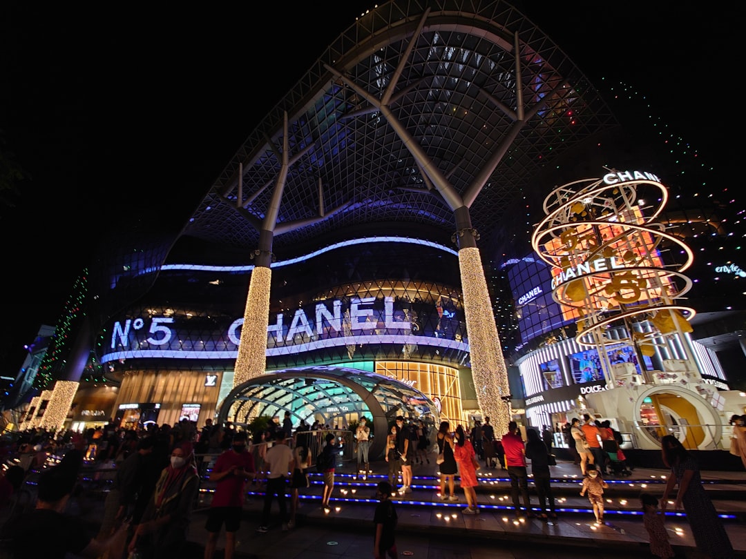 Shoppers browse a luxury retail mall in Singapore during Singapore Grand Prix season, with elevated foot traffic visible