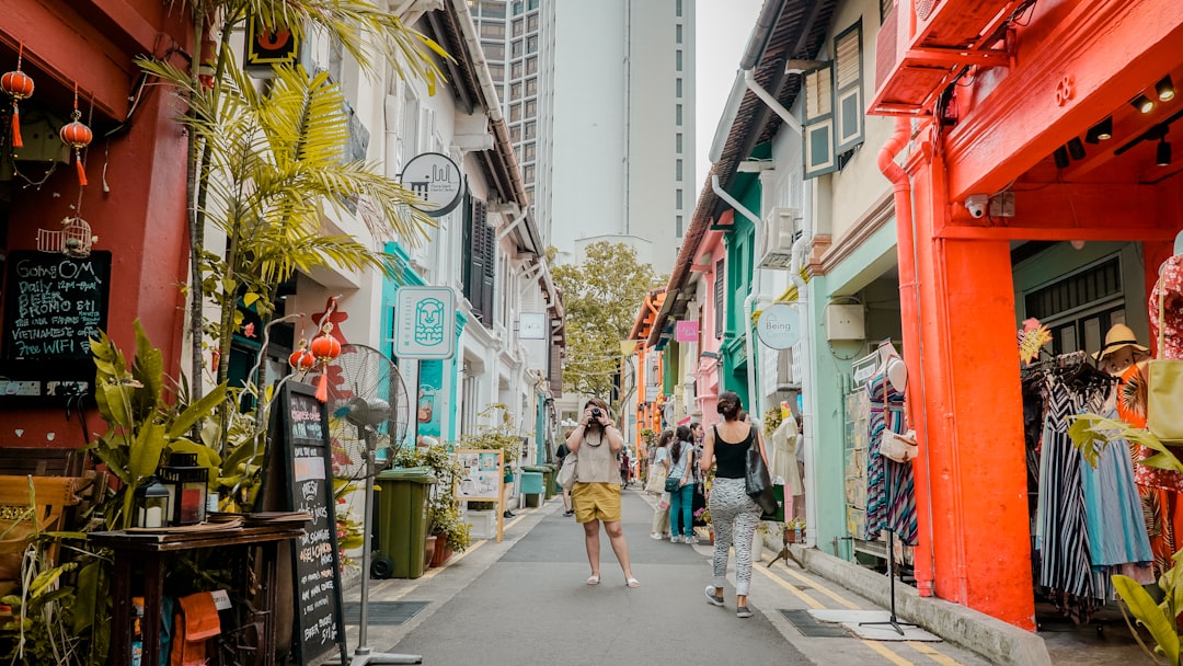 A family walking past colourful Katong shophouses in Singapore's Peranakan culture quarter