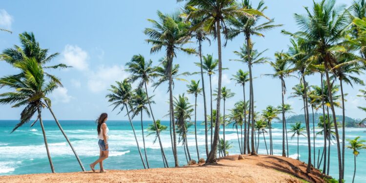 woman-beach-tropical-unsplash - SINwebzine A cyclist exploring a quiet village road on one of the best day trips from Singapore at Pulau Ubin