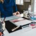 woman-linocut-printmaking-studio-unsplash - SINwebzine A beginner carving a linoleum block at one of Singapore's printmaking studios during a hands-on workshop session