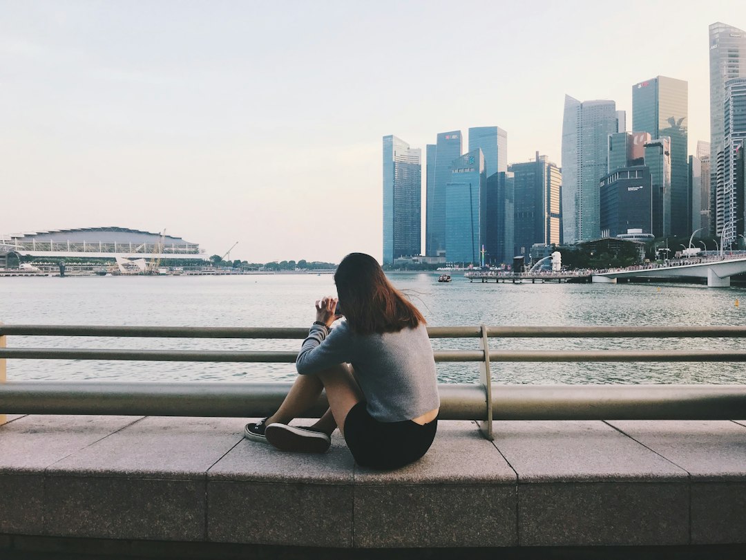 A woman walking in morning sunlight to support her sleep reset and restore energy after a disrupted Singapore night