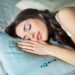 woman-sleeping-cool-bedroom-fan-unsplash - SINwebzine A woman achieving a sleep reset in a cool, fan-ventilated Singapore bedroom on a hot September night