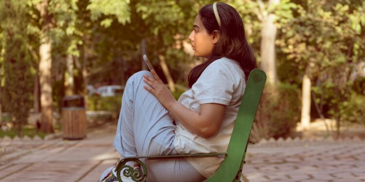 Woman checks an air quality app during haze season in Singapore