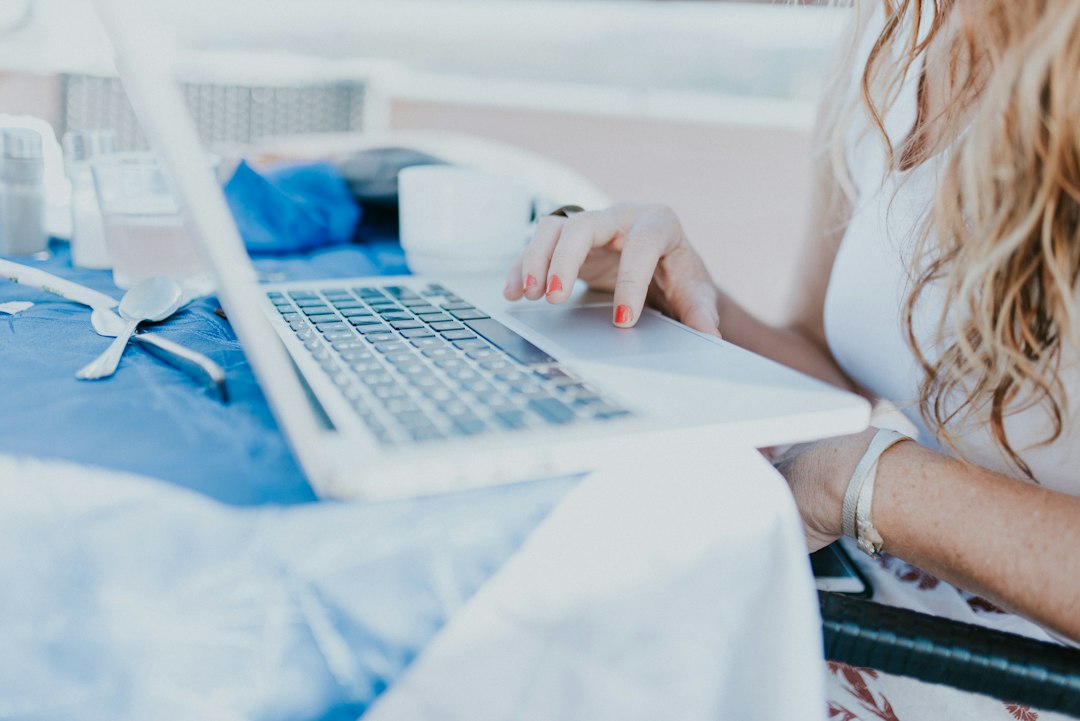 Woman booking year-end flights on a laptop at home in Singapore