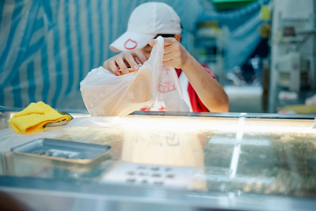 Food safety inspector reviewing hygiene grades record at a stall