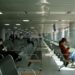 Year-end flights from Singapore when to book photo 1 - SINwebzine Traveler comparing year-end flights deals on a phone at Changi Airport