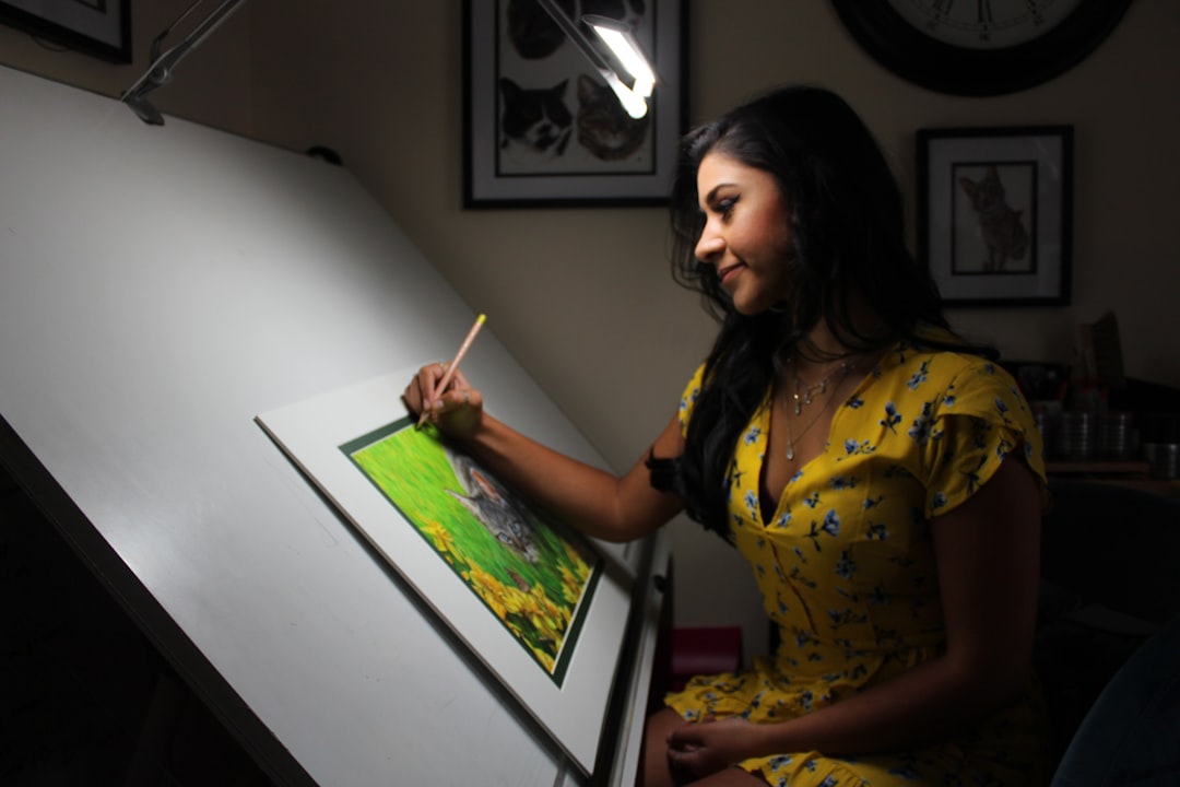 A Singapore illustrator works at her table during the illustration arts fest, surrounded by hand-drawn prints on display