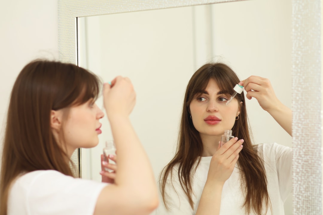 A woman applying a Singapore beauty brand botanical serum to her face in a bright tropical setting