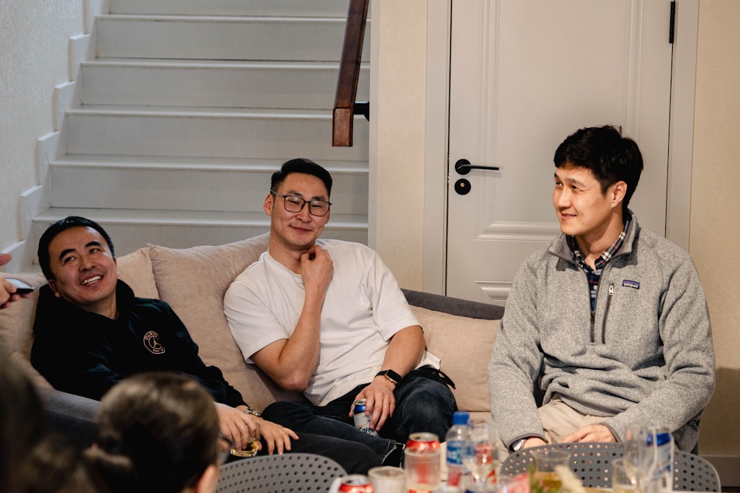 Un gruppo di amici di Singapore che esulta insieme mentre guarda la gara del Gran Premio di Singapore su uno schermo televisivo a casa